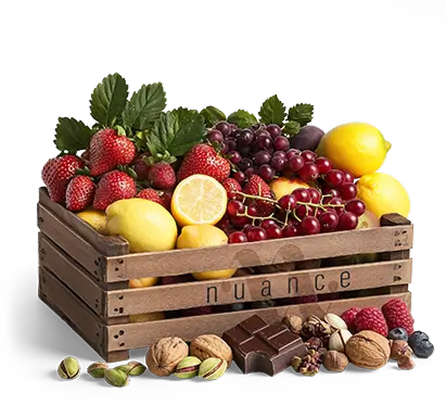 A wooden crate overflowing with fresh NUANCE ingredients: strawberries, lemons, grapes, chocolate, nuts and vanilla