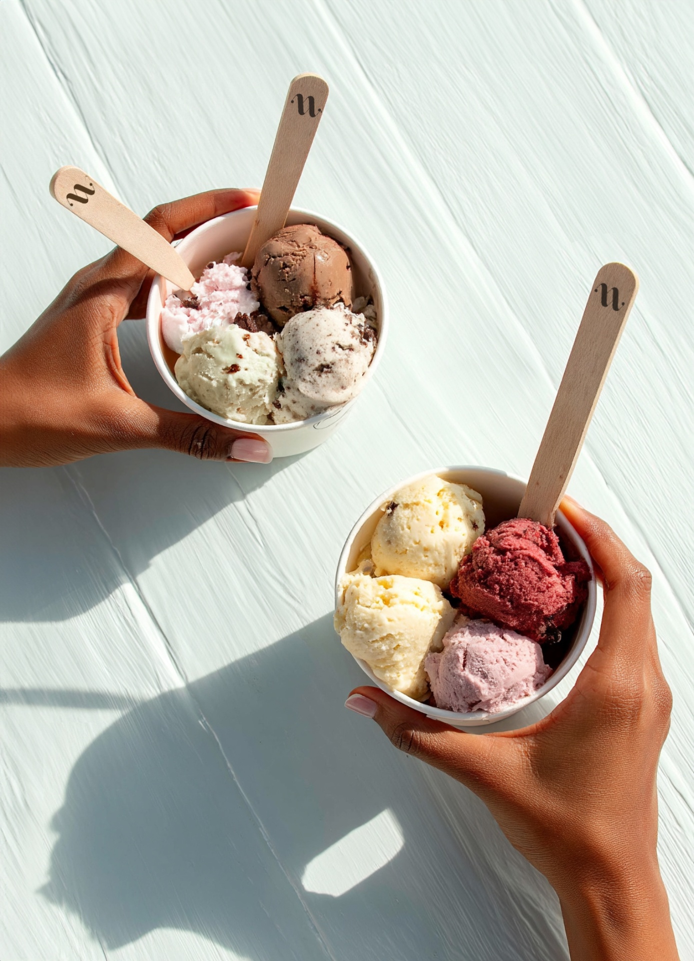 Hands holding freshly scooped NUANCE gelato cups